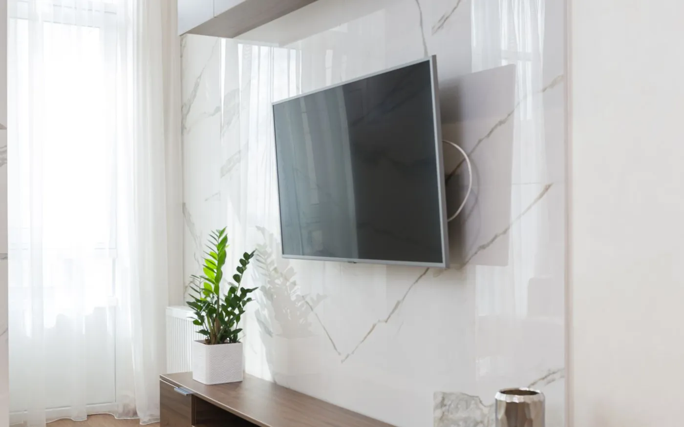 Modern wall-mounted OLED TV showing a clear, sharp picture after service